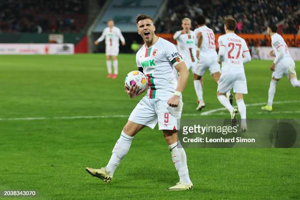 Ermedin Demirovic of FC Augsburg celebrates his team's first goal scored by Felix Uduokhai of FC Augsburg nduring the Bundesliga match between FC...