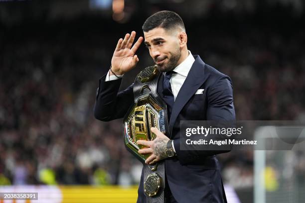 Ilia Topuria, UFC Featherweight Champion, is seen with his belt on the pitch prior to the LaLiga EA Sports match between Real Madrid CF and Sevilla...