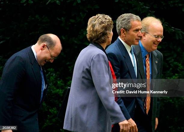 President George W. Bush walks with Counselor to the President Karen Hughes, Senior Advisor Karl Rove and Deputy Chief of Staff Joe Hagin after...