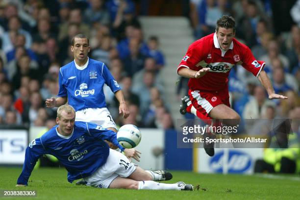 Tony Hibbert of Everton and Franck Queudre of Middlesbrough challenge during the Premier League match between Everton and Middlesbrough at Goodison...