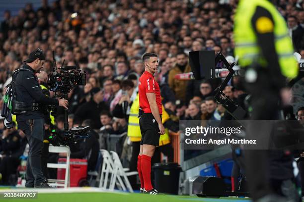 Referee Isidro Diaz de Mera checks the VAR monitor before disallowing the goal scored by Lucas Vazquez of Real Madrid during the LaLiga EA Sports...