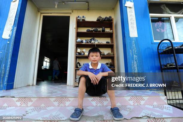 Cao Xiangqian a child living at Sun Village on the outskirts of Beijing on July 3 arrived from Guangxi province a year with his 5-year-old brother,...