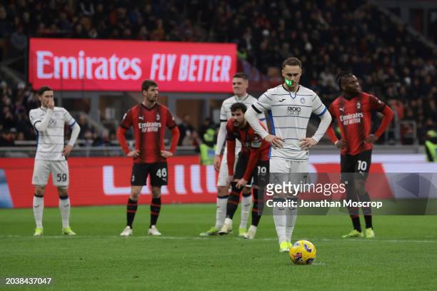 Laser light is shone on the face of Teun Koopmeiners of Atalanta as he waits to take a penalty during the Serie A TIM match between AC Milan and...