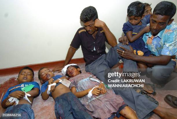 Man weeps in front of the bodies of his three children, victims of a powerful mine blast, at a make shift morgue in the main hospital at...