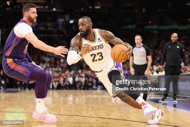 LeBron James of the Los Angeles Lakers drives the ball against Jusuf Nurkic of the Phoenix Suns during the first half of the NBA game at Footprint...