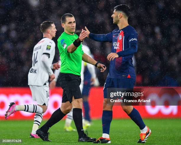 Referee Bastien Dechepy shakes hands with Marco Asensio of PSG during the Ligue 1 Uber Eats match between Paris Saint-Germain and Stade Rennais FC at...