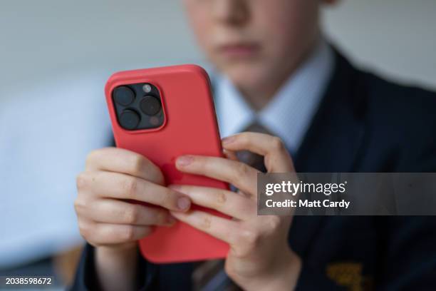 In this photo illustration a a 12-year-old school boy looks at a iPhone screen on February 25, 2024 in Bath, England. This week the UK government...