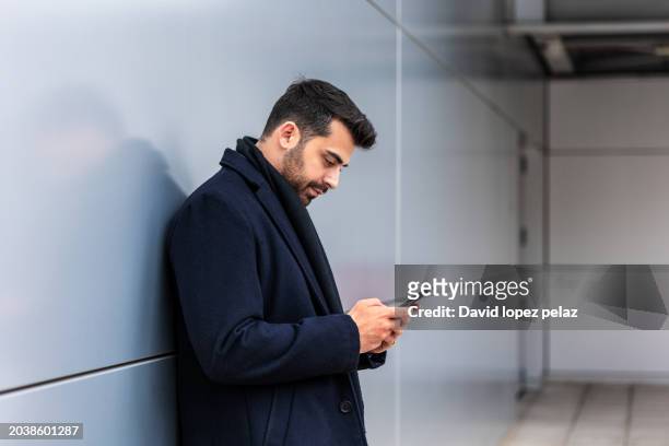 modern professional engrossed in smartphone technology. - 2000 teleworking stock pictures, royalty-free photos & images