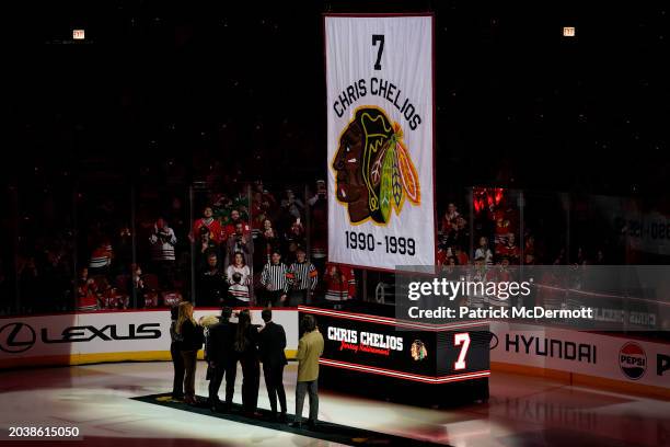 Former Chicago Blackhawks player Chris Chelios and his family watch as his number is lifted to the rafters during a jersey retirement celebration...