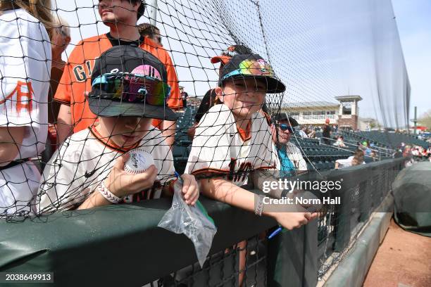 Young fans of the San Francisco Giants look to get autographs before a spring training game against the Texas Rangers at Surprise Stadium on February...