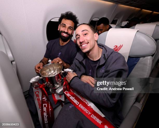 Mohamed Salah and Kostas Tsimikas of Liverpool with the Carabao Cup on the flight back to Liverpool after the Carabao Cup Final between Chelsea and...