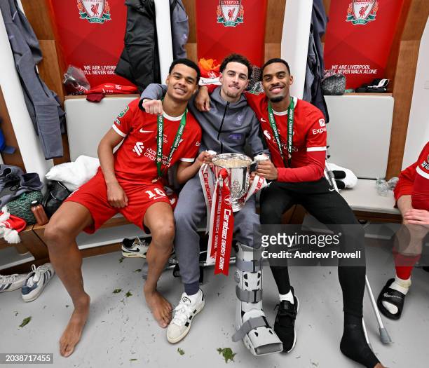 Cody Gakpo, Curtis Jones and Ryan Gravenberch of Liverpool with the Carabao Cup in the dressing room after the Carabao Cup Final between Chelsea and...