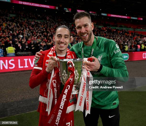 Adrian and Kostas Tsimikas of Liverpool with the Carabao Cup trophy at the end of the Carabao Cup Final between Chelsea and Liverpool at Wembley...