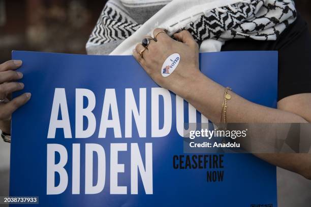 Farah Khan, a volunteer with Abandon Biden Campaign holds a sign near a voting site to encourage voters to vote 'uncommitted' in Michigan Primary...