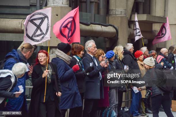 Protesters holding Extinction Rebellion flags form a human chain during the demonstration outside Lloyd's Building. Extinction Rebellion activists...