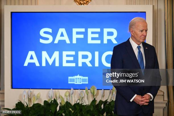 President Joe Biden waits to speak about his administration's efforts to fight crime and make communities safer, in the State Dining Room of the...