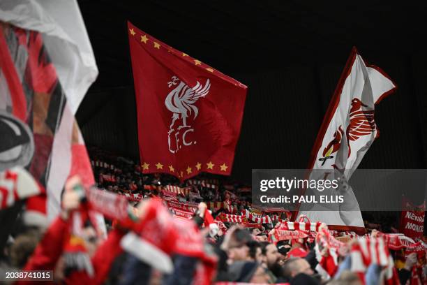 Liverpool fans waves flags in the crowd ahead of kick-off in the English FA Cup fifth round football match between Liverpool and Southampton at...