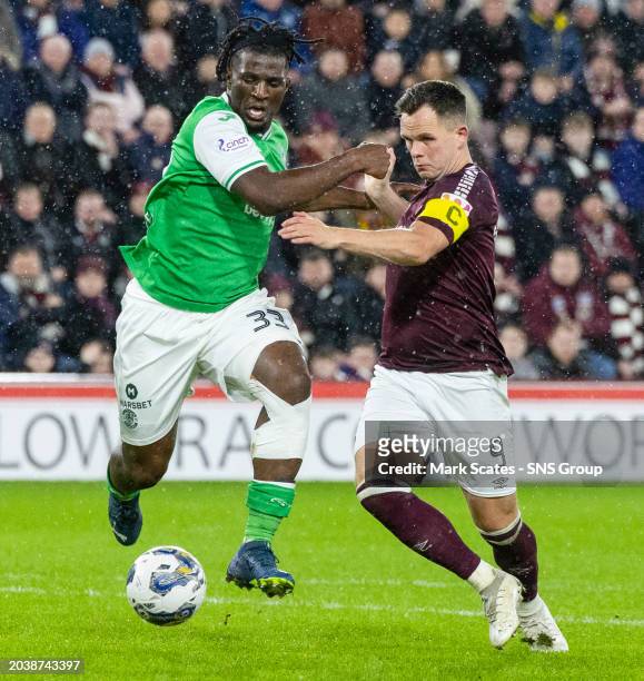 Hearts' Lawrence Shankland and Hibernian's Rocky Bushiri in action during a cinch Premiership match between Heart of Midlothian and Hibernian at...