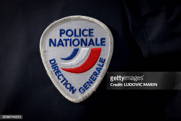 This photograph taken on February 28 shows a coat-of-arms of France's National Police during the final ceremony marking the graduation of French...