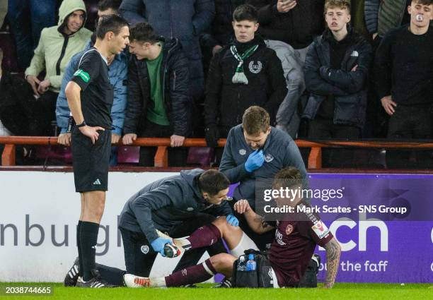 Hearts' Frankie Kent goes down injured during a cinch Premiership match between Heart of Midlothian and Hibernian at Tynecastle Park, on February 28...