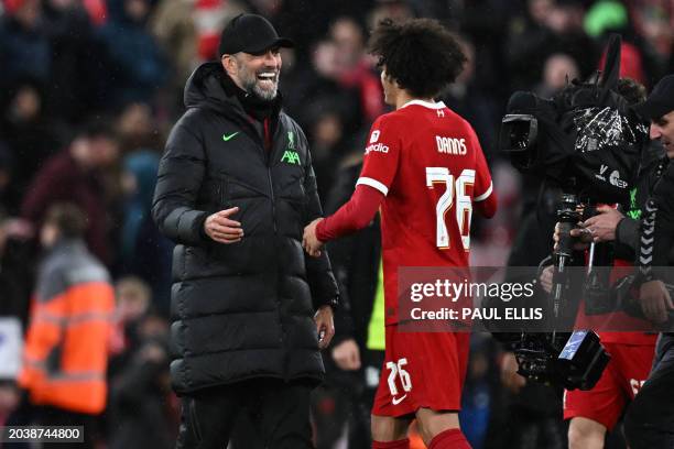 Liverpool's German manager Jurgen Klopp celebrates with Liverpool's English striker Jayden Danns on the pitch after the English FA Cup fifth round...