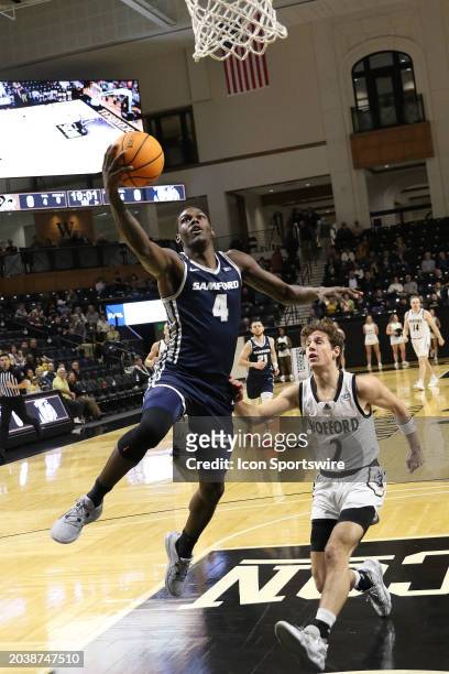 Samford Bulldogs forward Jermaine Marshall shoots a break away lay up with Wofford Terriers guard Dillon Bailey defending on the play during a...