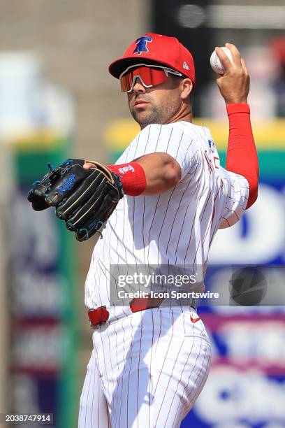 Philadelphia Phillies second baseman Whit Merrifield throws the ball over to first base during the spring training game between the Atlanta Braves...