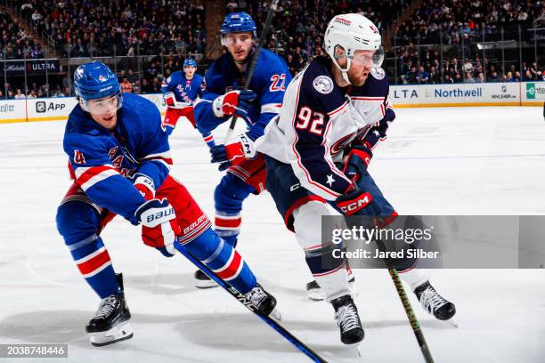 Alexander Nylander of the Columbus Blue Jackets skates with the puck against Braden Schneider and Jonny Brodzinski of the New York Rangers at Madison...