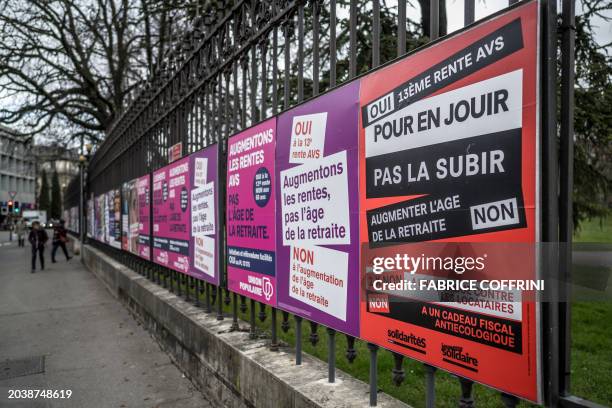 This photograph taken on February 27 shows, referendum posters in Geneva, Switzerland, ahead of two national referendum on retirement initiatives,...