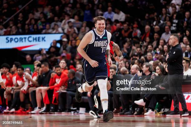 Luka Doncic of the Dallas Mavericks smiles as he runs back on defense against the Toronto Raptors in the second half of their NBA game at Scotiabank...