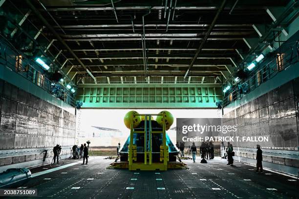 The Orion crew module test capsule rests in the well deck aboard the USS San Diego at Naval Base San Diego following the Underway Recovery Test 11 in...