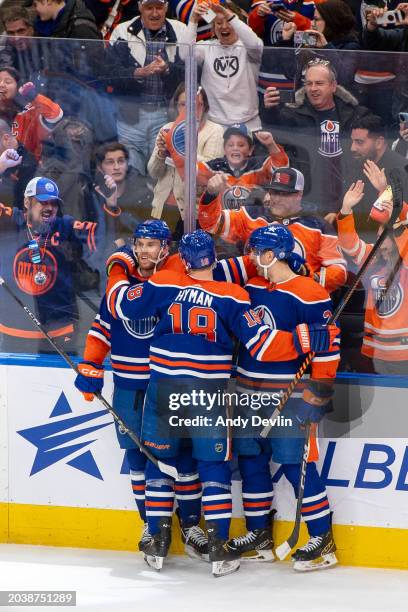 Connor McDavid of the Edmonton Oilers celebrates his overtime game winning goal against the St. Louis Blues with teammates Zach Hyman and Evan...