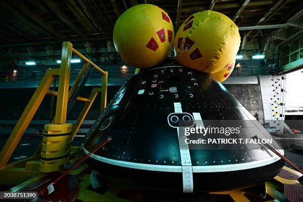 The Orion crew module test capsule rests in the well deck aboard the USS San Diego at Naval Base San Diego following the Underway Recovery Test 11 in...