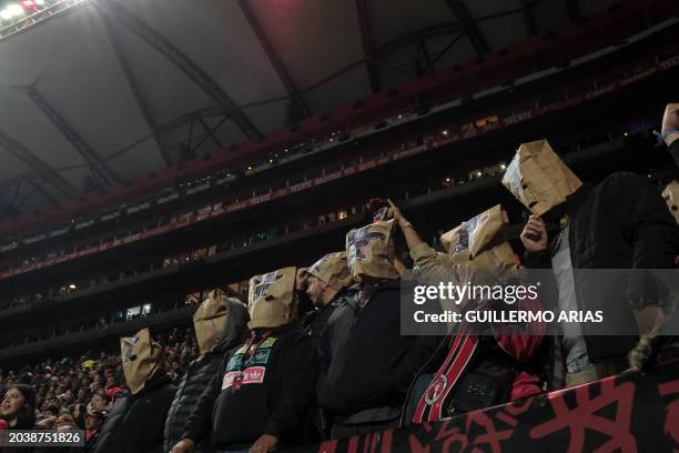 Tijuana's fans protest the team's performance by covering their heads with paper bags at the end of the Mexican Clausura tournament football match...