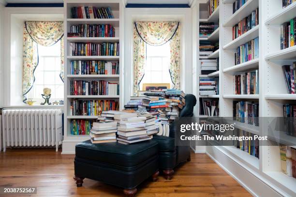 November 27: Books overwhelm an armchair in Lisa Scottoline's home in Malvern, Pennsylvania on November 27, 2023.