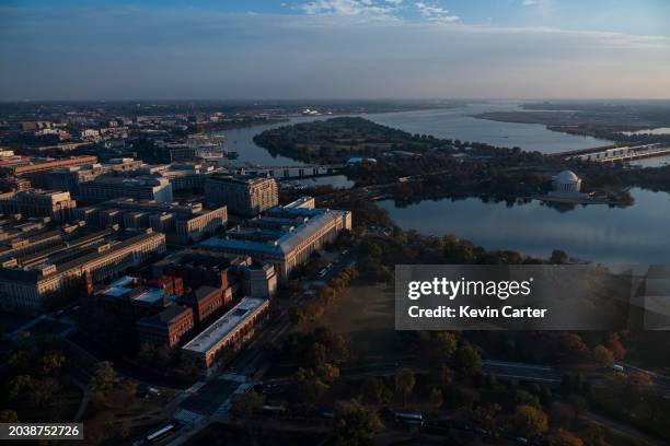 The afternoon sun shines on the United States Holocaust Memorial Museum and Bureau of Engraving and Printing near the Tidal Basin and Potomac River...