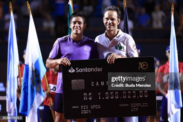 Sebastián Báez of Argentina receives the prize money check after winning the final match of ATP 500 Rio Open presented by Claro at Jockey Club...