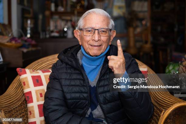 older senior latino man looking at the camera and giving the number one sign, i voted - online voting stock pictures, royalty-free photos & images