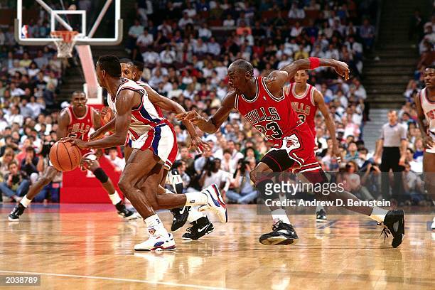 Michael Jordan of the Chicago Bulls persues Isiah Thomas of the Detroit Pistons during the 1989 season NBA game at The Palace Of Auburn Hills in...