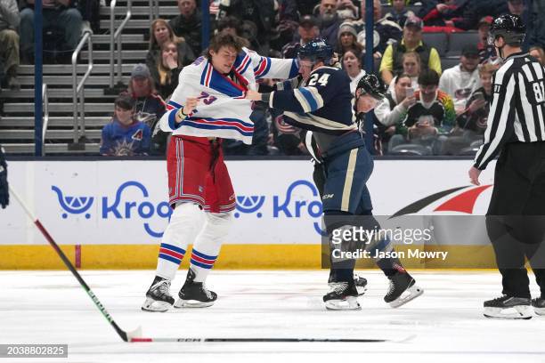 Matt Rempe of the New York Rangers fights with Mathieu Olivier of the Columbus Blue Jackets during the first period at Nationwide Arena on February...