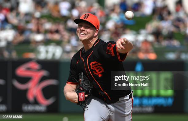 Kyle Harrison of the San Francisco Giants delivers a warm up pitch against the Texas Rangers during a spring training game at Surprise Stadium on...