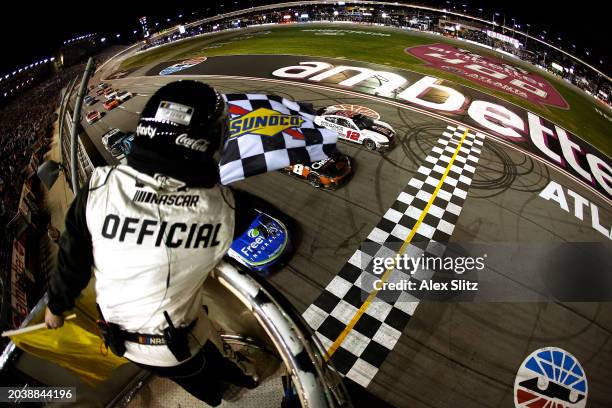 Daniel Suarez, driver of the Freeway Insurance Chevrolet, crosses the finish line ahead of Kyle Busch, driver of the Cheddar's Scratch Kitchen...