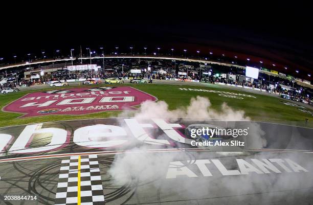 Daniel Suarez, driver of the Freeway Insurance Chevrolet, celebrates with a burnout after winning the NASCAR Cup Series Ambetter Health 400 at...