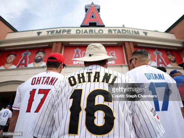 Three Shohei Ohtani fans pose for a photo during a spring training exhibition between the Los Angeles Angels and the Los Angeles Dodgers at the...