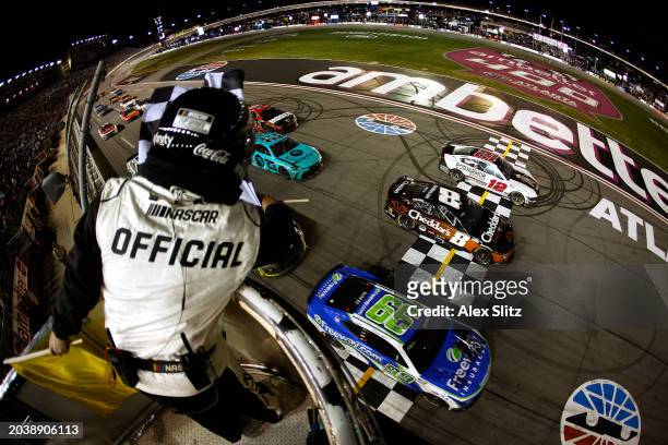 Daniel Suarez, driver of the Freeway Insurance Chevrolet, crosses the finish line ahead of Kyle Busch, driver of the Cheddar's Scratch Kitchen...