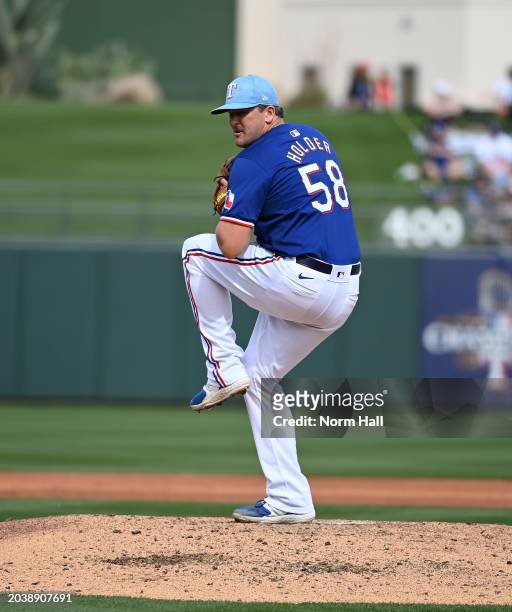 Jonathan Holder of the Texas Rangers delivers a pitch against the San Francisco Giants during a spring training game at Surprise Stadium on February...