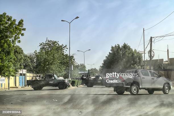 Picture taken throough a car window shows Chadian soldiers barring the entrance to the road leading to the headquarter of the Chadian opposition...