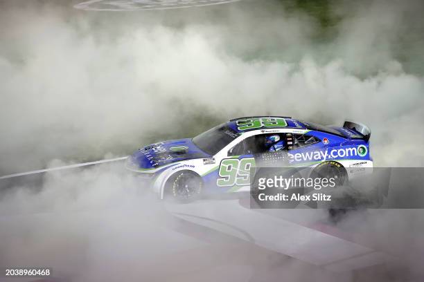 Daniel Suarez, driver of the Freeway Insurance Chevrolet, celebrates with a burnout after winning the NASCAR Cup Series Ambetter Health 400 at...
