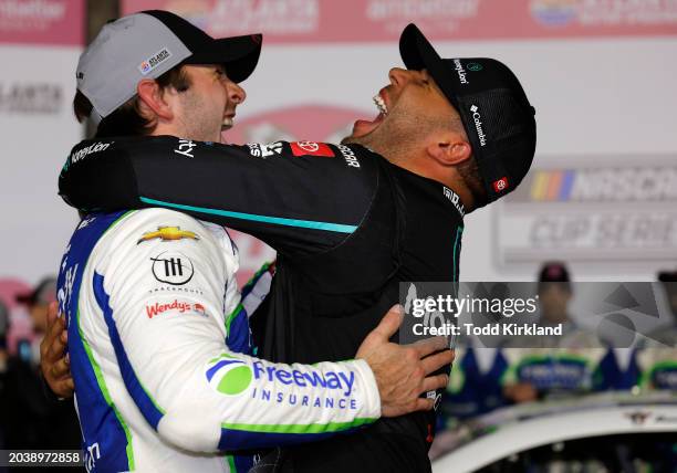 Daniel Suarez, driver of the Freeway Insurance Chevrolet, is congratulated by Bubba Wallace, driver of the MoneyLion Toyota, in victory lane after...