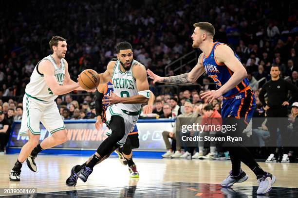 Jayson Tatum of the Boston Celtics is defended by Isaiah Hartenstein of the New York Knicks during the game at Madison Square Garden on February 24,...
